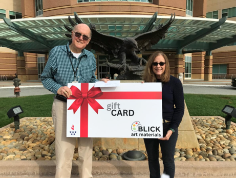Veterans Foundation representatives present a Blick art materials gift card